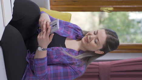 Vertical-video-of-Woman-texting-with-happy-expression.